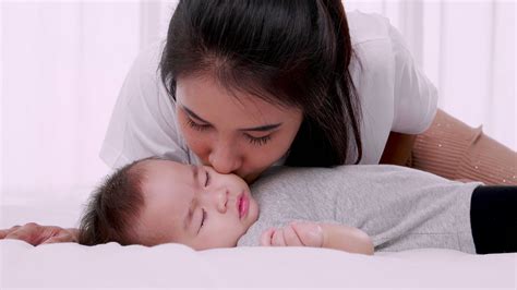 A Gentle And Loving Mother Kisses The Baby Slow Motion 8836907 Stock