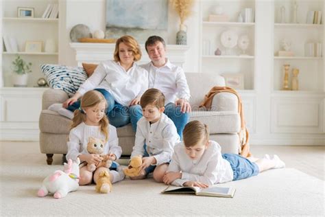 Cozy Dreamy Parents Enjoy Free Time Children Are Sitting On Carpet