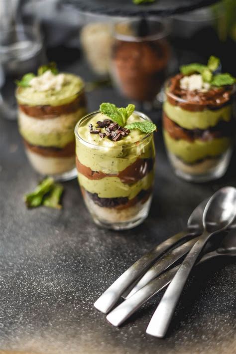 Three Desserts With Spoons On A Table