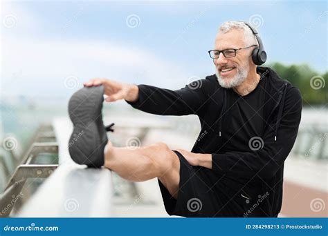 Happy Positive Mature Retired Sportsman Doing Legs Stretching Exercises