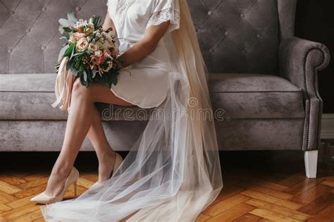 Bride In Silk Robe Putting On Stockings Wedding Morning Preparation