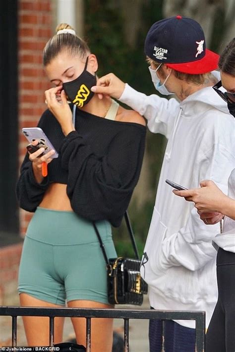 justin bieber tenderly holds his crop top clad wife hailey during loved up breakfast outing