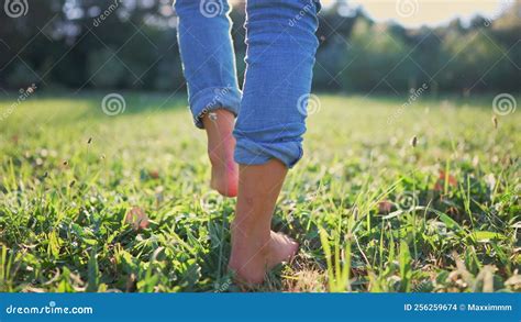 Bare Feet Walking On The Grass A Teenager Girl Takes Off Her Shoes