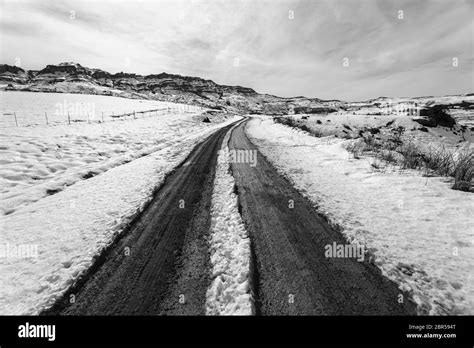 Mountains Snow Dirt Road Tracks Towards Hilltop In Vintage Black And
