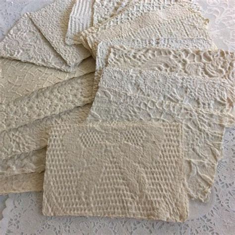 Several Pieces Of White Lace Laid On Top Of Each Other