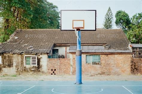 Old Brick House Behind A Street Basketball Court And The Hoop With Big