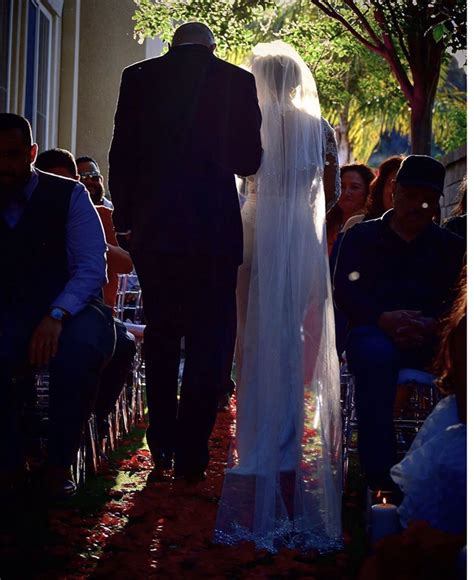 The Bride And Groom Are Walking Down The Aisle