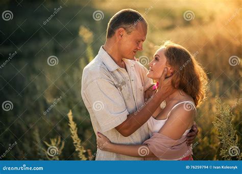 Cheerful Couple In Love Embracing And Looking At Each Other Stock Photo