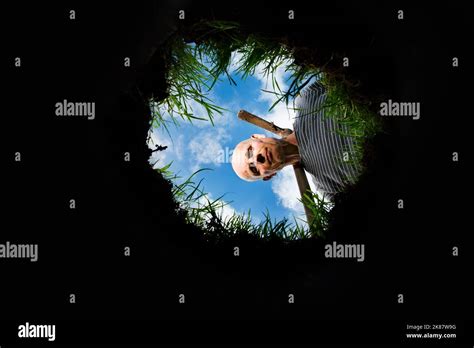 A Man Looking Into A Hole Stock Photo Alamy