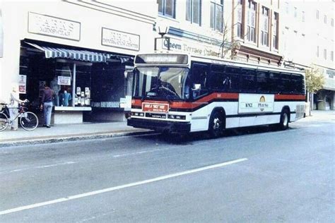 A Bus Is Parked On The Side Of The Road In Front Of A Storefront