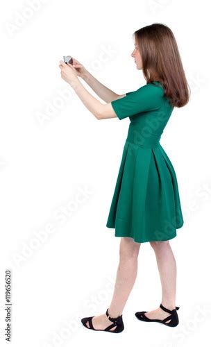 Back View Of Standing Young Beautiful Woman Using A Mobile Phone Girl
