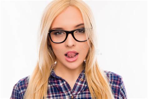 Portrait Of Young Pretty Girl In Glasses Showing Tongue Stock Photo