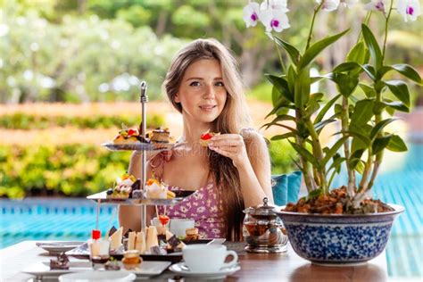 Woman Eat Tart Cake Desserts Assortment In Outdoor Resort Restaurant