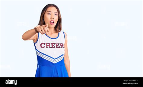 Young Beautiful Chinese Girl Wearing Cheerleader Uniform Pointing