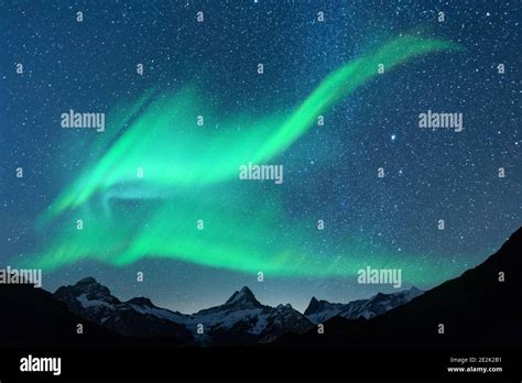 Aurora Borealis Northern Lights In Winter Mountains Sky With Polar