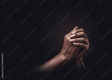 Praying Hands With Faith In Religion And Belief In God On Dark