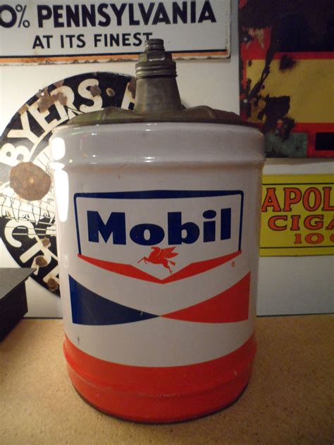An Old Mobil Oil Can Sitting On A Table