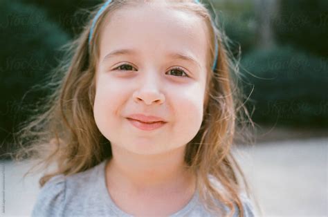 Close Up Portrait Of A Cute Young Girl With Big Cheeks By Stocksy Contributor Jakob