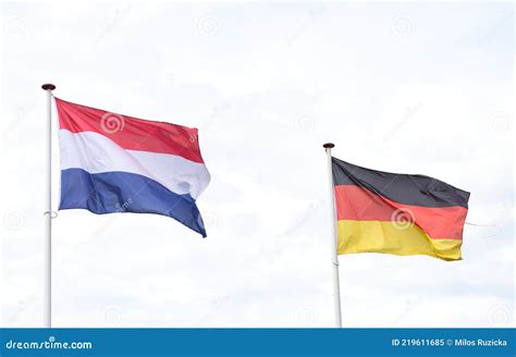 flags of the netherlands and germany in the wind isolated side by side stock image image of