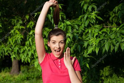 Funny Girl In Pink Shirt Pulling Her Hair Up And Look Surprised Stock