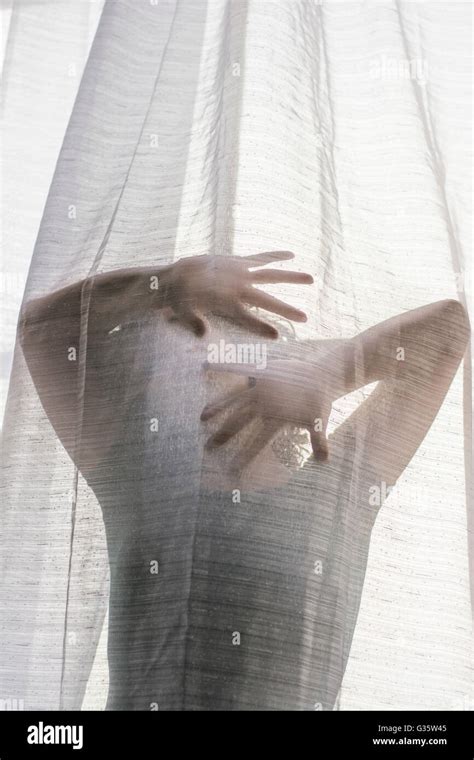 Young Woman Hiding Face With Hands Behind The Blinds Stock Photo Alamy