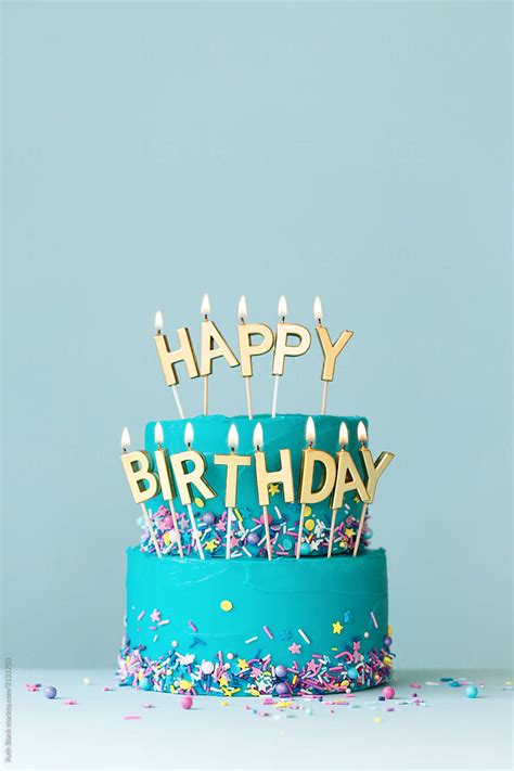 Turquoise Birthday Cake With Golden Candles By Stocksy Contributor