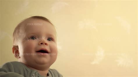 Portrait Of Little Baby Boy Standing In The Crib And Jumping With Smile