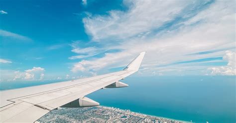 Aerial Shot Of Airplane Wing City And Sea Landscape · Free Stock Photo