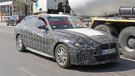But why wait til tonight when we've got the pics right now? BMW i4 electric vehicle spied out testing with interior ...