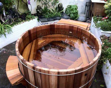 Both supply jet massages in a tub. Round wood hot tub with full circle bench | Whirlpool deck ...