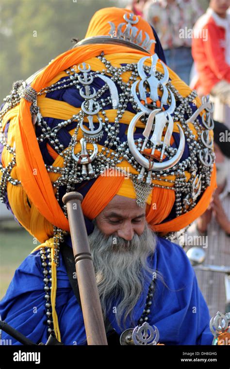 traditional sikh warrior or nihang with a huge traditional turban decorated with sikh symbols in
