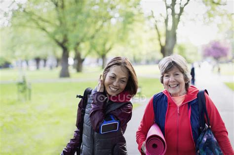 Active Senior Women Friends With Yoga Mat Walking In Park — Portable