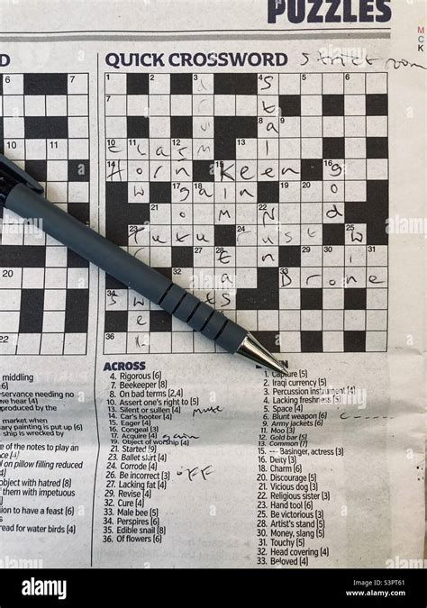 Crossword Puzzle Half Completed With Pen Stock Photo Alamy