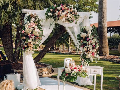 An Outdoor Wedding Setup With Flowers And Greenery