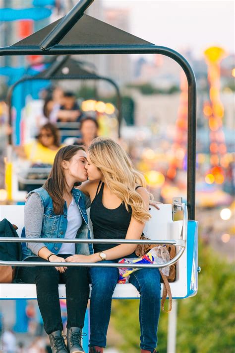 women kissing on carnival ride by stocksy contributor jen grantham