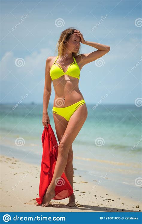 Very Beautiful Slim Woman With A Perfect Figure Stands And Poses On A