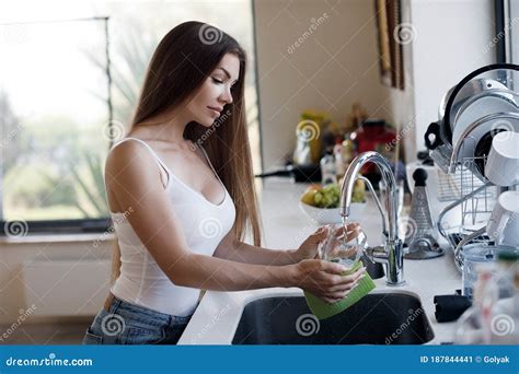 Beautiful Woman Doing Cleaning At Home And Wash Dishes Stock Image