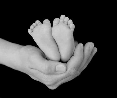 Baby Feet In Hands Rise