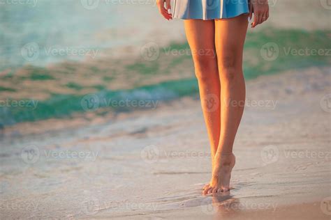 Female Legs On The Beach Closeup Girl Walking On The Beach