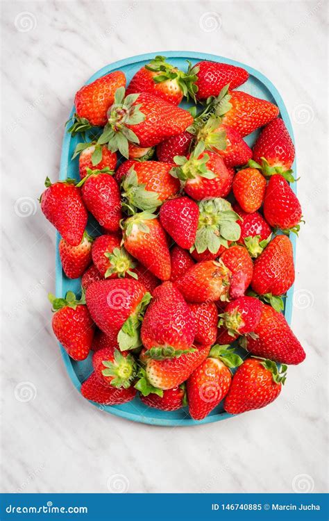 Wooden Tray With Freshly Picked Strawberries On White Marble Table