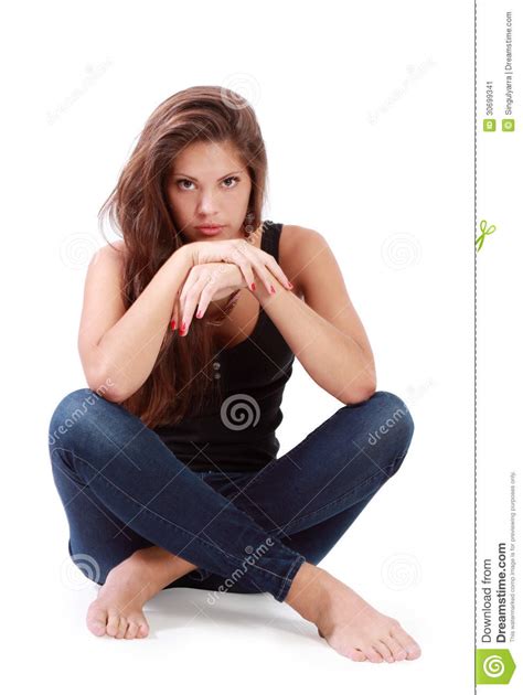 Young Brunette Woman Sits On Floor With Bended Knees Stock Image