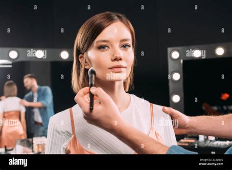Makeup Artist Applying Face Powder On Beautiful Model Stock Photo Alamy