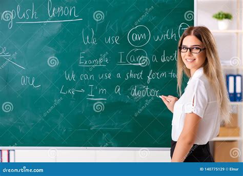 The Young Female English Language Teacher Standing In Front Of The