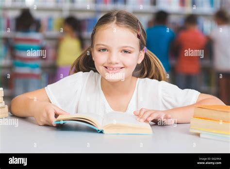 Schoolgirl Reading Book In Library Stock Photo Alamy