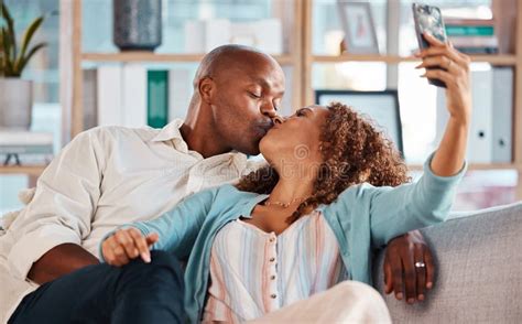 Couple Selfie And Kiss On Sofa In Home Living Room Bonding Or Having