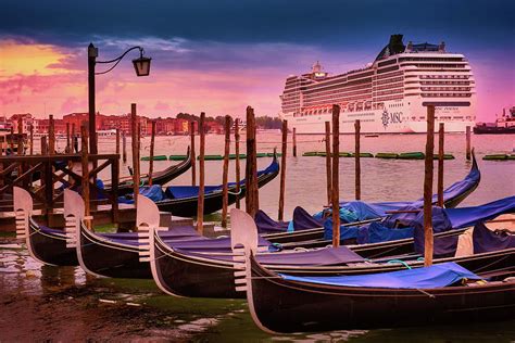 Gondolas And Cityscape At Sunset In Venice Italy
