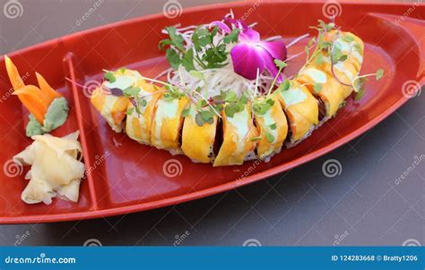 Large Orange Platter Filled With The Tempting Array Of Sushi Roll