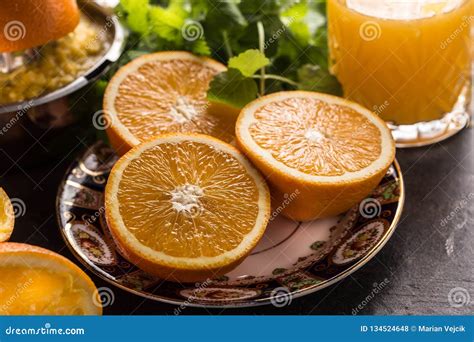 Fresh Oranges Juicer Juice Tropical Fruits And Herbs On Concrete Board