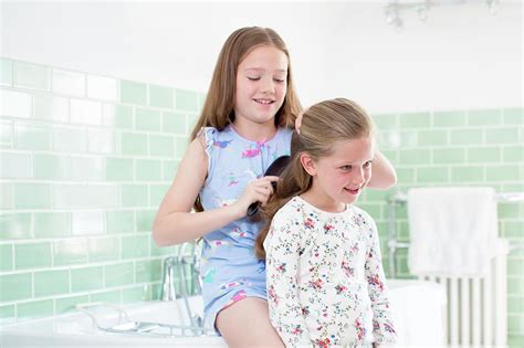 Big Sister Brushing Little Sisters Hair Photograph By Science Photo Library Pixels Merch