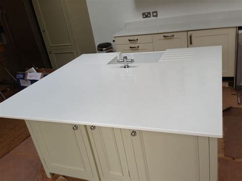 Quartz surfaces are highly resistant to stain and scratch and made to almost any conceivable colour and design. #Unistone #Carrara quartz #island worktop in 20mm with # ...